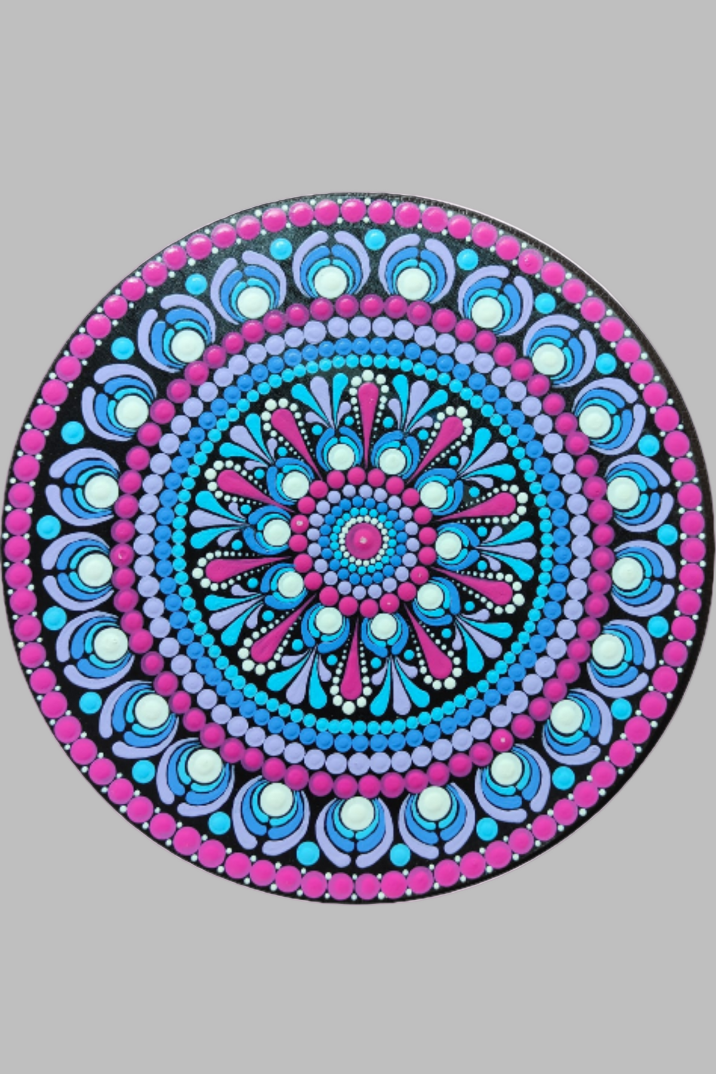 Decorative circular wall art with a mandala design on a wall
