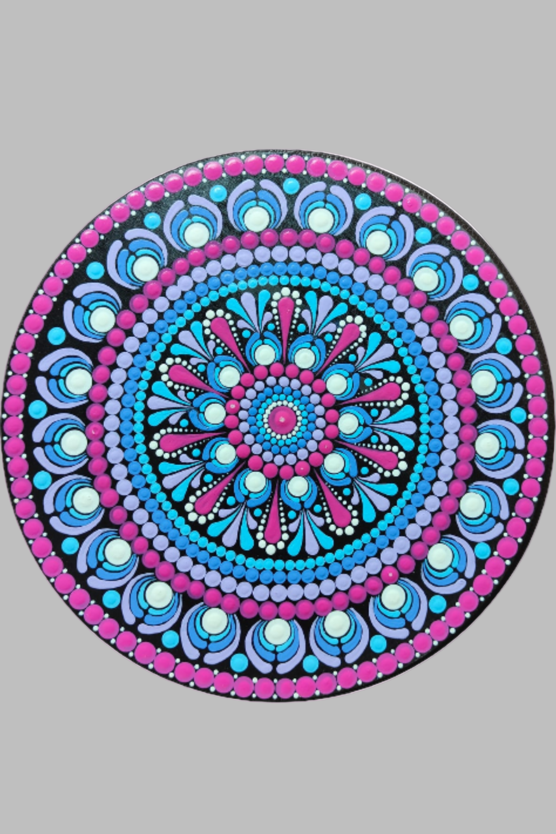 Decorative circular wall art with a mandala design on a wall